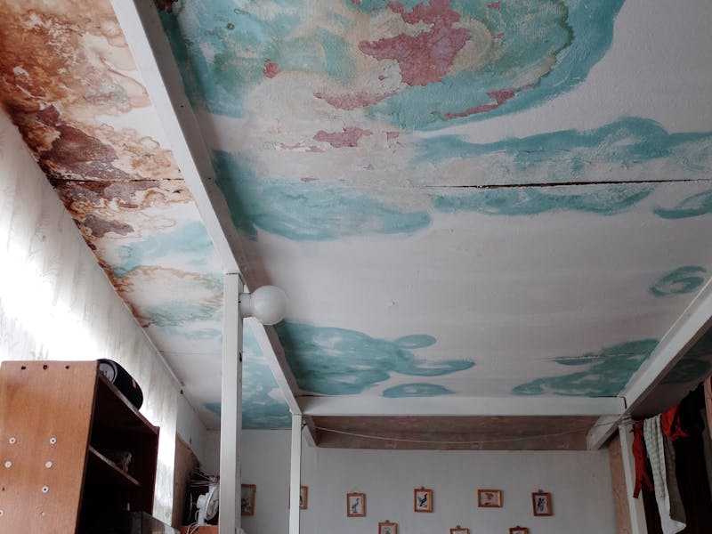 Terrace before waterproofing, showing water stains and damage